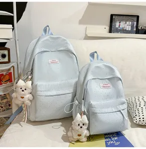 Light blue polka dot backpack set with cute bear pendant, stylish mini school bag for students.