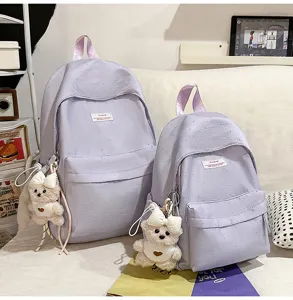 Cute purple dotted school backpack set with sweet bear pendant for daily student travel.
