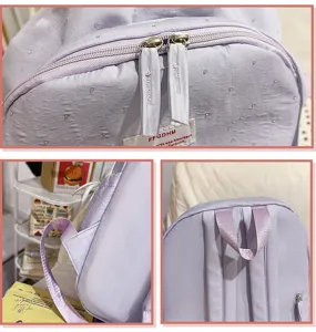 Cute mini light purple backpack detail showing zipper pulls and soft straps, sweet style.