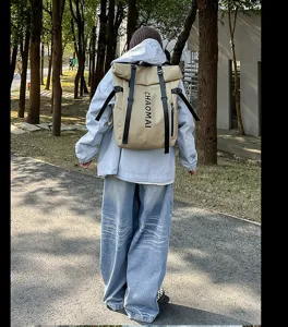 Detail view of casual outdoor travel backpack with roll-top design and adjustable straps.
