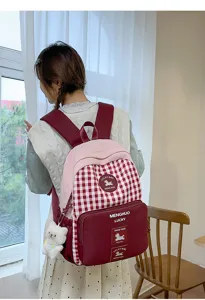 Detail view of a cute sweet red plaid backpack worn by model, showing large capacity and straps.