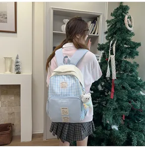 Japanese sweet plaid backpack for students, light large capacity school bag style.