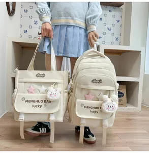 Canvas school bag set with cute plush rabbit charm and multi-compartment design for daily use.