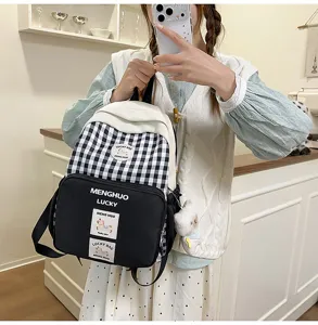 Detail view of sweet Japanese style black and white plaid student school backpack with front pocket.