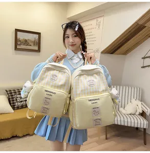 Japanese style sweet plaid backpack for students, large capacity casual school bookbag with cute charm.