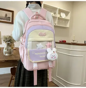 Pink color block school backpack for girls with cute plush rabbit pendant and multi compartments.