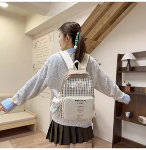 Japanese style plaid backpack for women, cute school bag with large capacity and cute pendant.