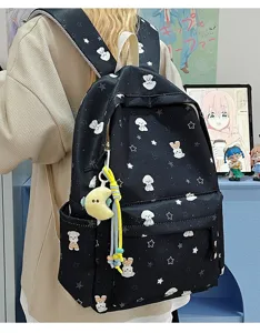 Detail view of the black Japanese style student backpack with cute puppy star print and charm.