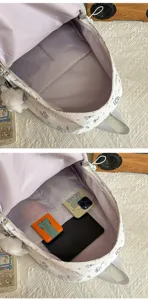 Detail view of the cute cartoon cat printed student backpack interior with large capacity storage.