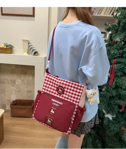 Student campus cross-body canvas bag with red plaid design, large capacity and cute bear pendant.