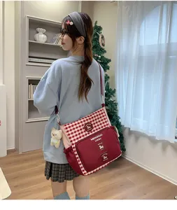 Canvas school shoulder bag for students, casual plaid crossbody tote bag with cute bear pendant.