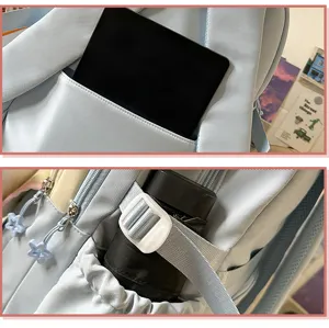 Detail view of light blue school backpack featuring multi compartments and large storage capacity.