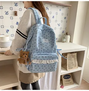 Korean style cute blue corduroy backpack for girls with bowknot patterns and lace ruffles.