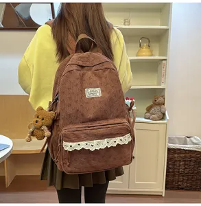 Brown corduroy backpack for women, cute school bookbag with bow pattern and bear pendant.