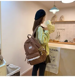 Korean style brown corduroy backpack for women, cute school bag with lace and bear pendant.
