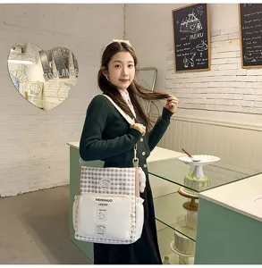Stylish canvas crossbody bag for students, chic plaid design with large capacity daily use.
