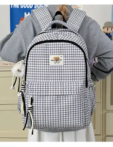 Cute black and white plaid backpack with bear patch and plush pendant, school bag for girls.