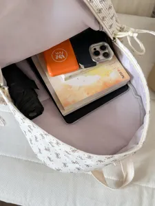 Korean ins style white bow backpack student school bag with large capacity interior.
