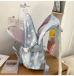 Detailed view of cute Japanese style blue school backpack with white stars and rabbit pattern.