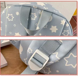 Detailed view of cute blue backpack with white star print, showing sturdy straps and adjustable buckle.