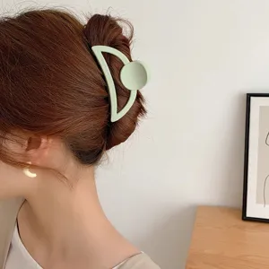 Matte green geometric hair claw clip for women, large shark hair clip for elegant back head styling.