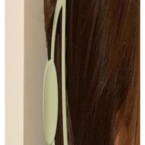 Minimalist matte green hair claw clip close-up, elegant hair accessory for daily styling.