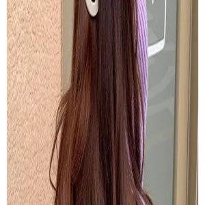 Detail shot showing a stylish matte white hair claw clip worn on long brown hair.