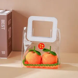 Detailed view of handmade crochet orange ornament in transparent gift bag, car interior decor.