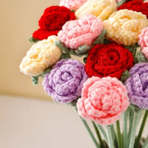 Handmade crochet rose bouquet detail, colorful yarn knitted floral close up view.