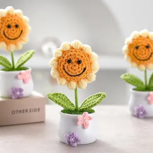 Handmade crochet sunflower potted plant detail showing cute smiling face design for home.