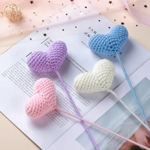 Handmade crochet heart flower stems detail, soft yarn craft bouquet decor for lovely gifts.