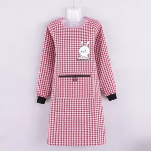 Long sleeve plaid apron detail showing cute rabbit print and zipper pocket design.