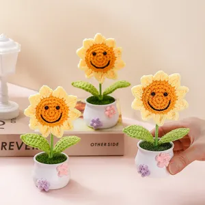 Detailed shot of crochet smiley sunflower potted plant, cute handmade wool home decor gift.