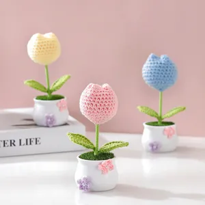 Detailed view of handmade crochet tulip potted plants, cute wool floral decor for desk.