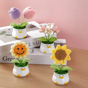 Detailed view of handmade crochet flower potted plant with cute duck ceramic pot for home decor.