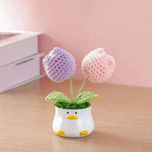 Handmade crochet tulip potted plant with cute duck ceramic vase, desktop decor detail.