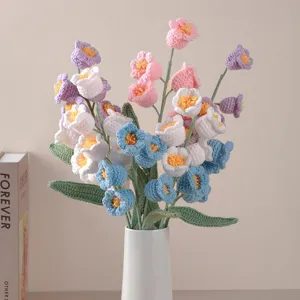Handmade crochet lily of the valley bouquet detail, vibrant colorful yarn flowers closeup.