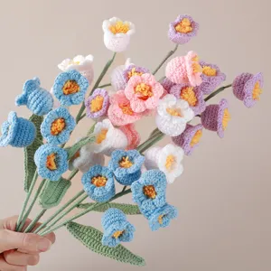 Handmade crochet lily of the valley flower bouquet detail, knitted yarn floral decor.