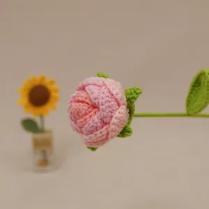 Handmade crochet gradient pink rose flower detail, exquisite knitted floral decor piece.