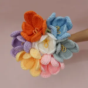 Closeup of handmade colorful crochet tulip bouquet detail, soft woolen flower craftsmanship.