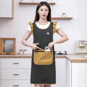 Stylish anti-fouling kitchen apron with ruffles, pockets, and durable waterproof fabric.
