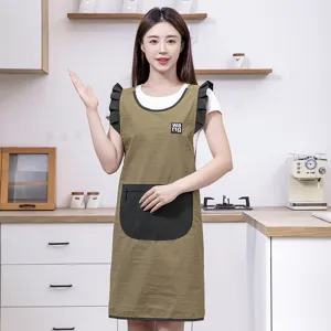 Waterproof kitchen apron for women with ruffles and pockets, stylish cooking baking wear.