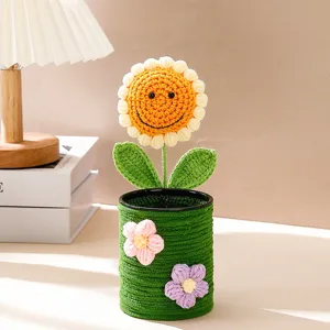 Handgemaakte gehaakte zonnebloem penhouder met schattig glimlachend gezicht en bloemdecoratie.