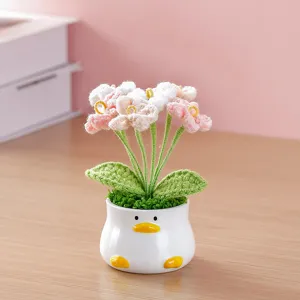 Handmade crochet flower potted plant with cute duck ceramic pot for home desktop decoration.