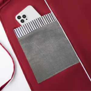 Waterproof kitchen apron pocket detail, premium red fabric with convenient hand wiping fleece cloth.