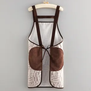 Detailed view of waterproof cross-back apron with convenient hand-wipe pockets and clean pattern.