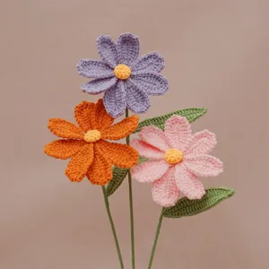 Close-up of handmade crochet woolen flowers bouquet showing vibrant purple, orange, and pink petals.