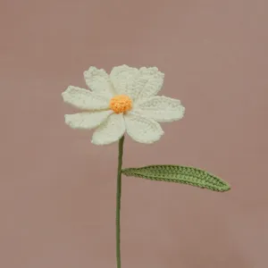 Handmade crochet daisy flower detail shot, delicate wool knit texture for cozy decor.