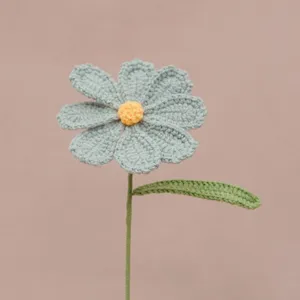 Handmade crochet flower detail view, beautiful blue petals and green stem design.