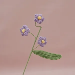 Handmade crochet puff flower branch detail shot, delicate knitting texture for home decor.